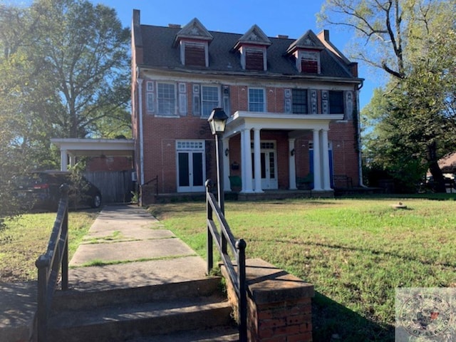 view of front of property with french doors and a front lawn