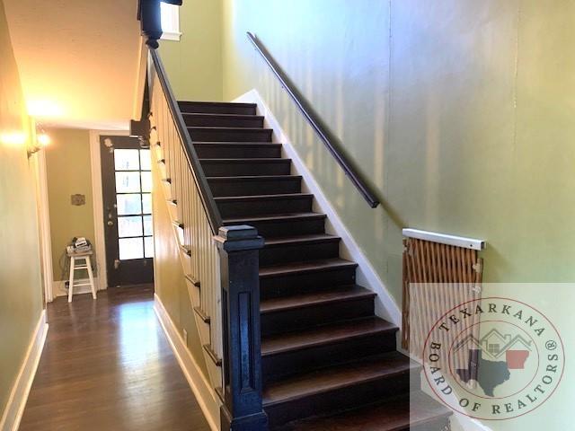 stairway with hardwood / wood-style floors