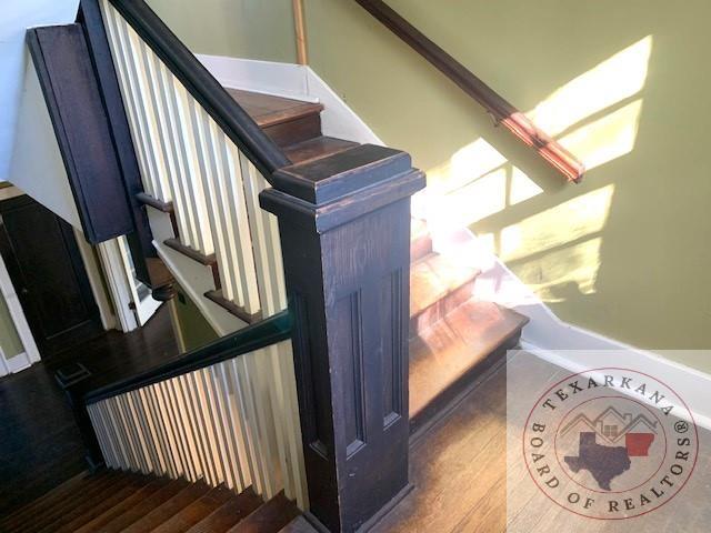 stairway with hardwood / wood-style floors