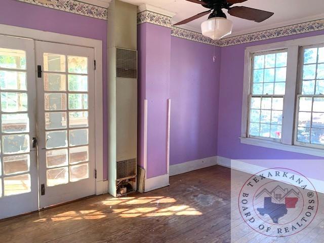 unfurnished bedroom featuring ceiling fan, french doors, and hardwood / wood-style floors