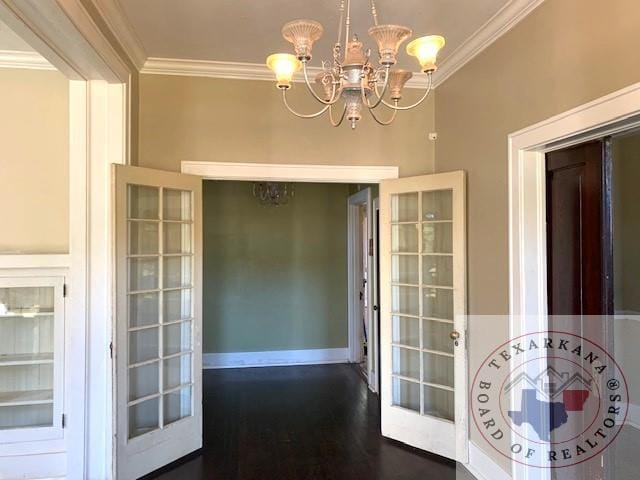 interior space featuring dark hardwood / wood-style flooring, crown molding, french doors, and an inviting chandelier