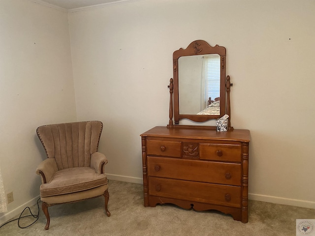 sitting room featuring crown molding and light carpet