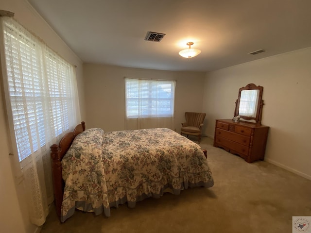 bedroom featuring light colored carpet