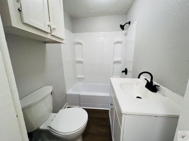 full bathroom with hardwood / wood-style floors, a textured ceiling, vanity, toilet, and shower / bathtub combination