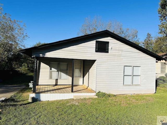 back of property featuring a lawn