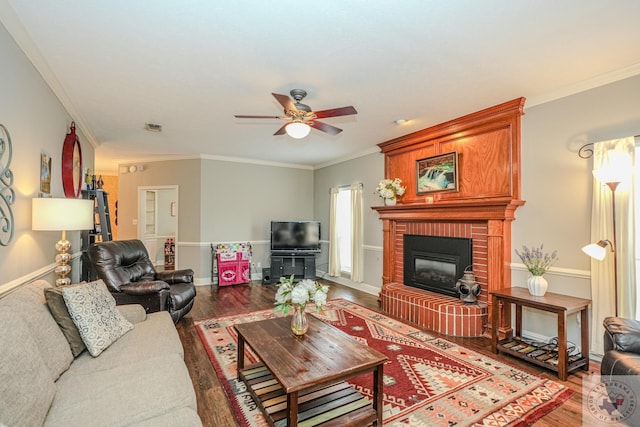 living room featuring visible vents, wood finished floors, a fireplace, and ornamental molding