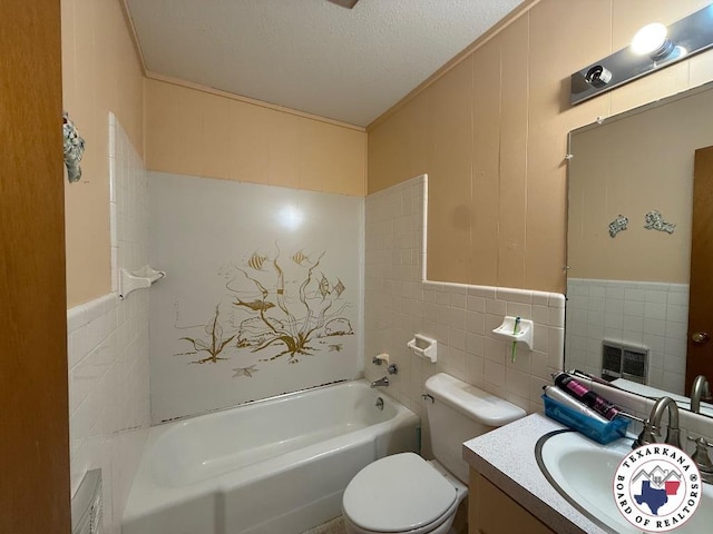 184 E Elliott Ln, Dekalb, TX 75559 - bathroom with tile walls, a textured ceiling, toilet, vanity, and ornamental molding