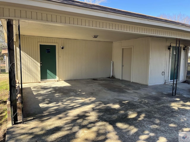 doorway to property featuring a carport