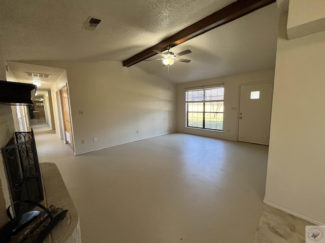 unfurnished living room featuring ceiling fan, a fireplace, lofted ceiling with beams, and a textured ceiling