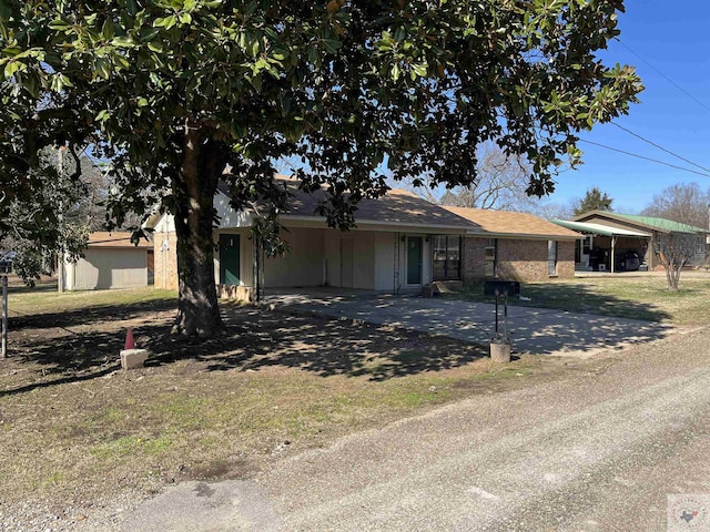 ranch-style house featuring a carport