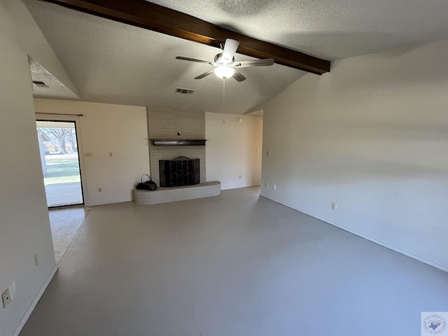 unfurnished living room with a brick fireplace, a textured ceiling, concrete floors, and vaulted ceiling with beams