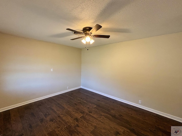 empty room featuring ceiling fan, a textured ceiling, and dark hardwood / wood-style floors