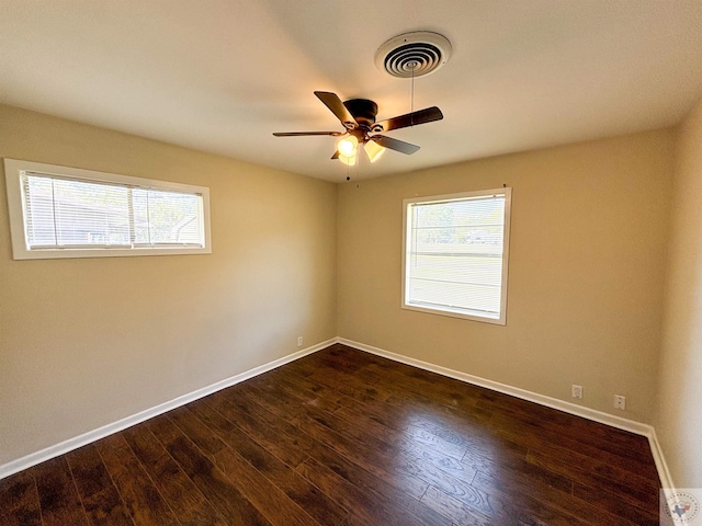 unfurnished room featuring ceiling fan and dark hardwood / wood-style floors