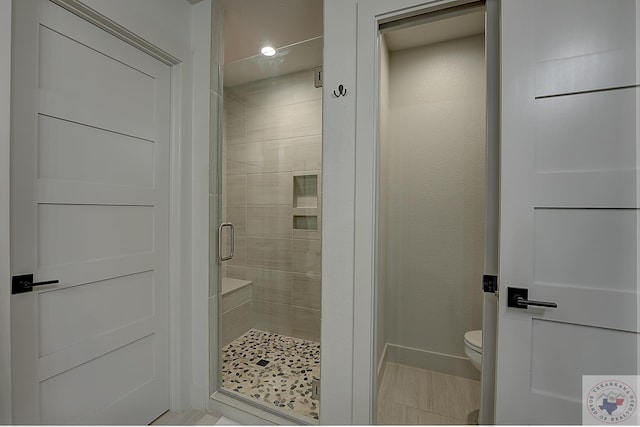 bathroom with toilet and walk in shower