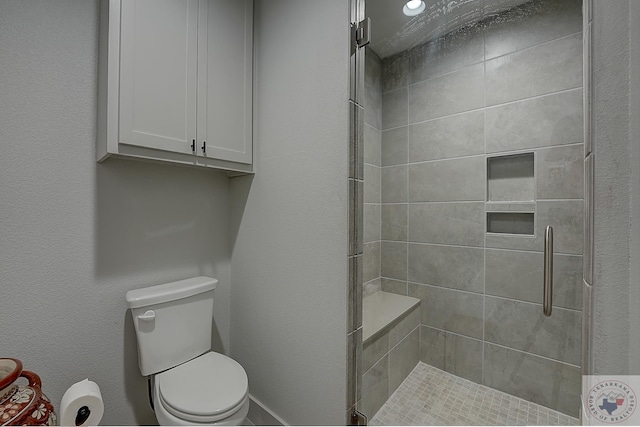 bathroom with toilet and walk in shower