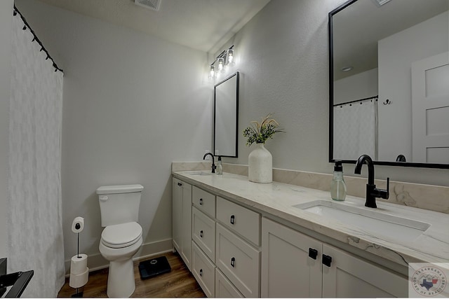 bathroom with wood-type flooring, a shower with curtain, toilet, and vanity