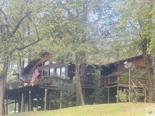 rear view of house featuring a deck