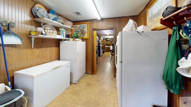 320 Riverside Dr, Horatio, AR 71842 - laundry room with light tile patterned flooring and wooden walls