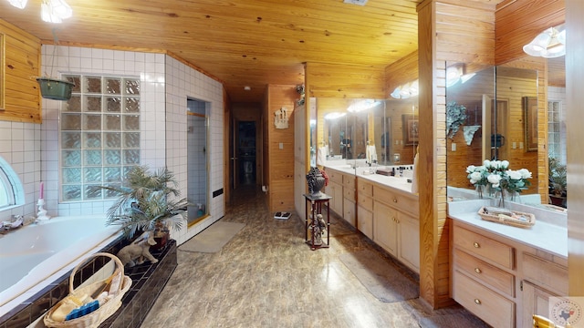 320 Riverside Dr, Horatio, AR 71842 - bathroom with tiled tub, vanity, wood walls, and wood ceiling