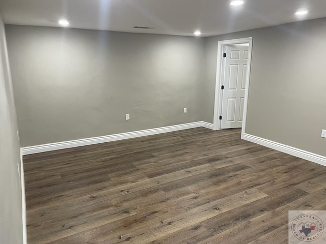 basement with dark hardwood / wood-style floors