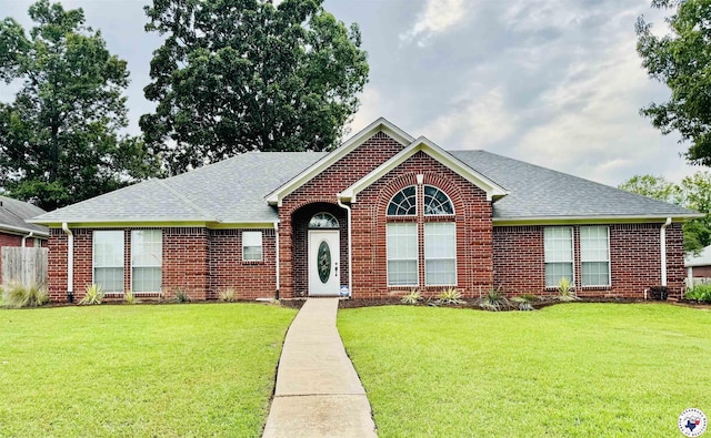 5611 Forest Bend Ln, Texarkana, AR 71854 - view of front of property featuring brick siding, roof with shingles, and a front yard