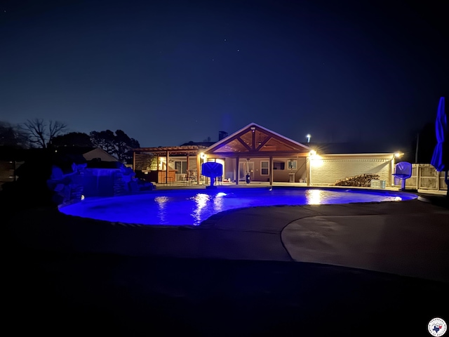 6515 N Kings Hwy, Texarkana, TX 75503 - pool at night featuring a patio area