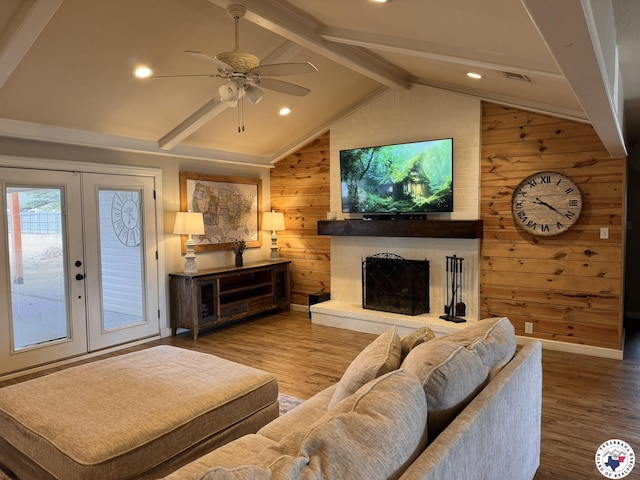 6515 N Kings Hwy, Texarkana, TX 75503 - living room with wooden walls, wood finished floors, a ceiling fan, a brick fireplace, and french doors