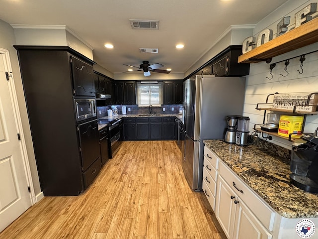 6515 N Kings Hwy, Texarkana, TX 75503 - kitchen with stainless steel appliances, dark cabinetry, a sink, ornamental molding, and recessed lighting