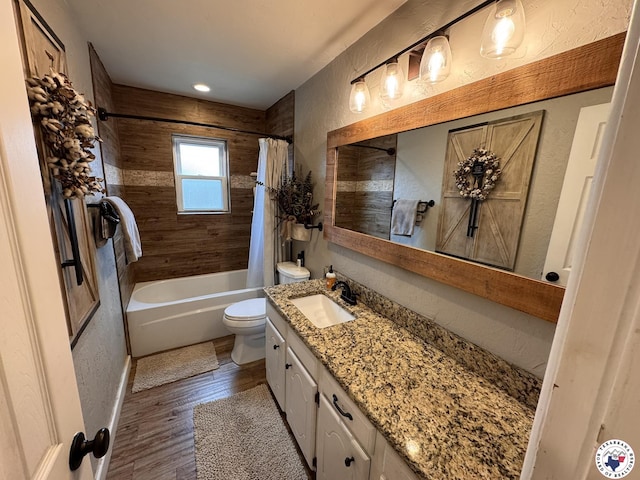 6515 N Kings Hwy, Texarkana, TX 75503 - full bathroom featuring vanity, toilet, wood finished floors, shower / bathtub combination with curtain, and a textured wall