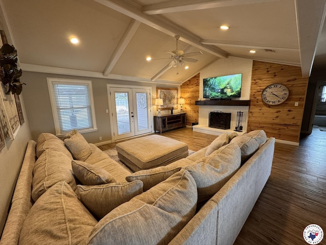 6515 N Kings Hwy, Texarkana, TX 75503 - living room featuring a fireplace with raised hearth, wooden walls, wood finished floors, ceiling fan, and baseboards