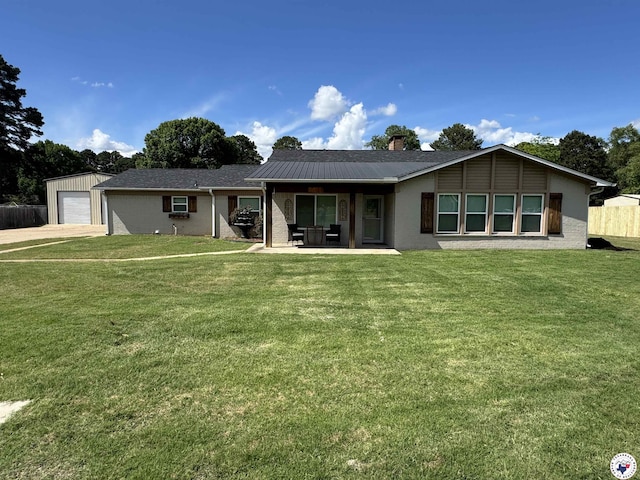 6515 N Kings Hwy, Texarkana, TX 75503 - rear view of house with a chimney, a detached garage, and driveway