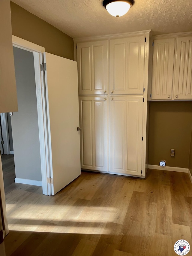 1 Sidney Dr, Texarkana, TX 75503 - unfurnished bedroom with light wood-type flooring, a textured ceiling, and baseboards
