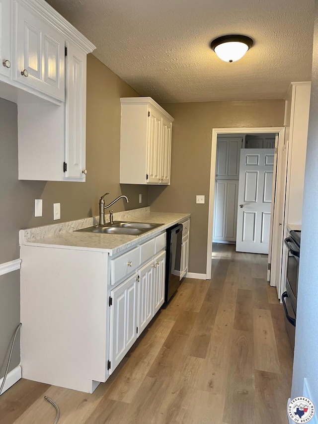 1 Sidney Dr, Texarkana, TX 75503 - kitchen with dishwashing machine, a sink, light wood-type flooring, white cabinets, and a textured ceiling
