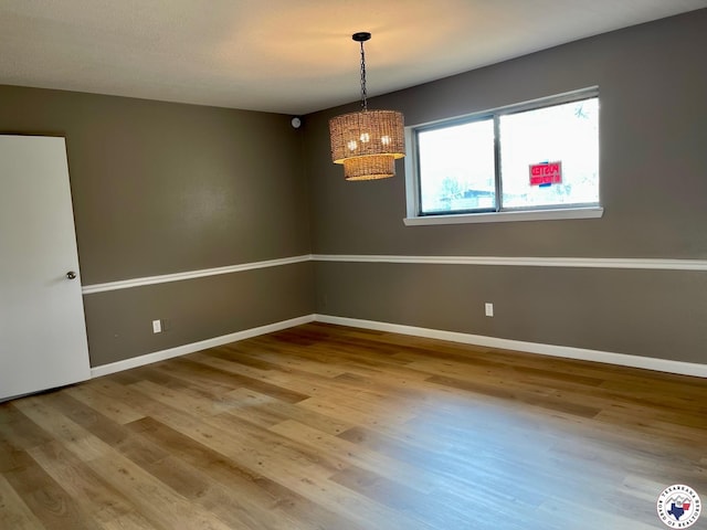 1 Sidney Dr, Texarkana, TX 75503 - empty room featuring a chandelier, wood finished floors, and baseboards