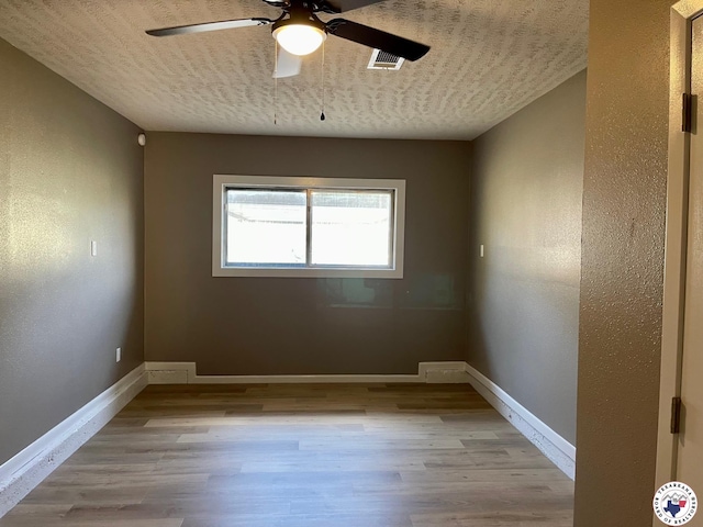 1 Sidney Dr, Texarkana, TX 75503 - spare room featuring ceiling fan, wood finished floors, baseboards, and a textured ceiling