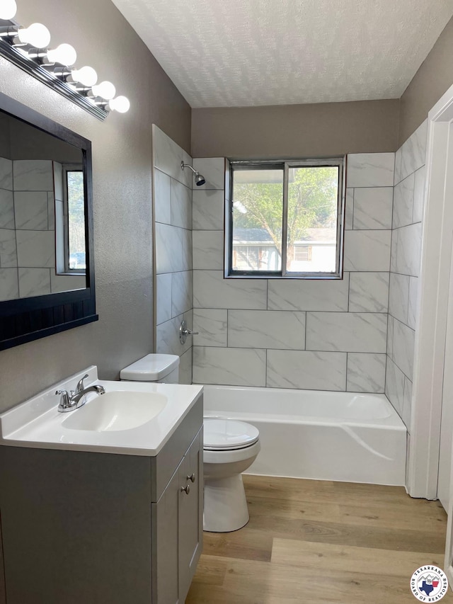1 Sidney Dr, Texarkana, TX 75503 - full bathroom featuring toilet, a textured ceiling, vanity, wood finished floors, and shower / bathtub combination