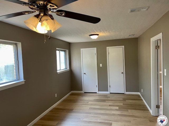 1 Sidney Dr, Texarkana, TX 75503 - unfurnished bedroom with a textured ceiling, light wood-type flooring, and baseboards