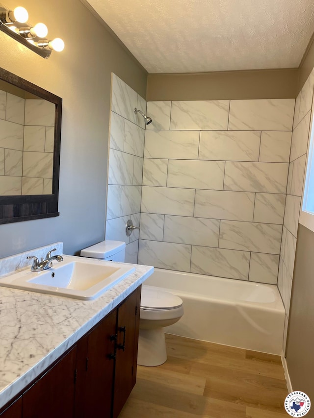 1 Sidney Dr, Texarkana, TX 75503 - full bathroom with toilet, wood finished floors, vanity, a textured ceiling, and shower / washtub combination