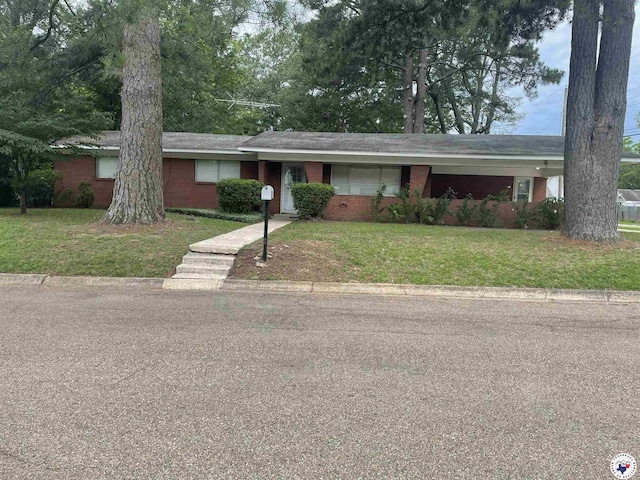 3123 Hickory St, Texarkana, AR 71854 - ranch-style home with brick siding, a front lawn, and a carport