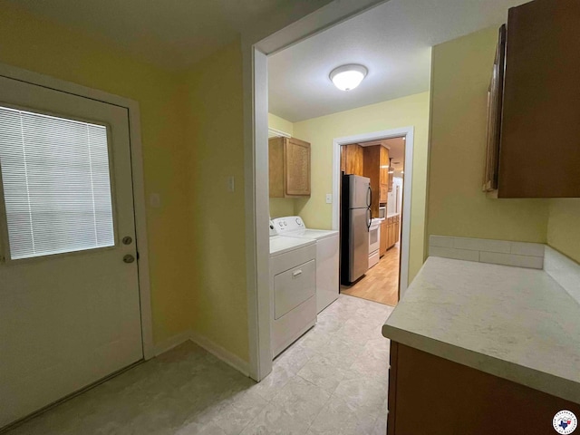 3123 Hickory St, Texarkana, AR 71854 - laundry room with cabinet space, washing machine and dryer, and light tile patterned floors