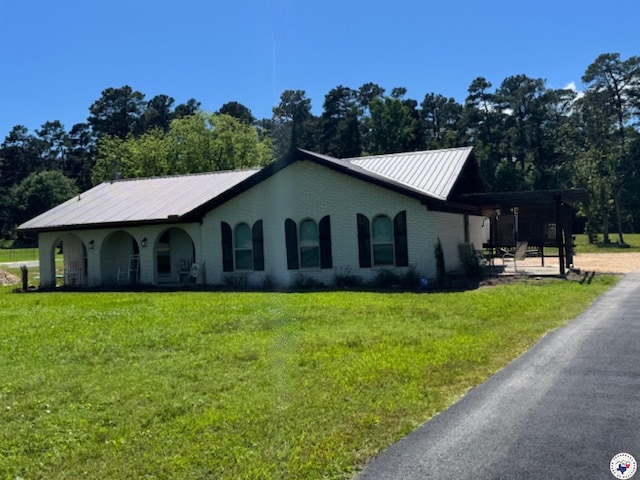 24075 US Highway 59 N, Queen City, TX 75551 - ranch-style house featuring a front yard, metal roof, brick siding, and view of scattered trees