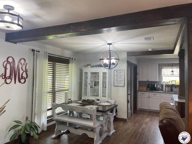 24075 US Highway 59 N, Queen City, TX 75551 - dining area with a chandelier, beamed ceiling, dark wood-style floors, a textured ceiling, and baseboards
