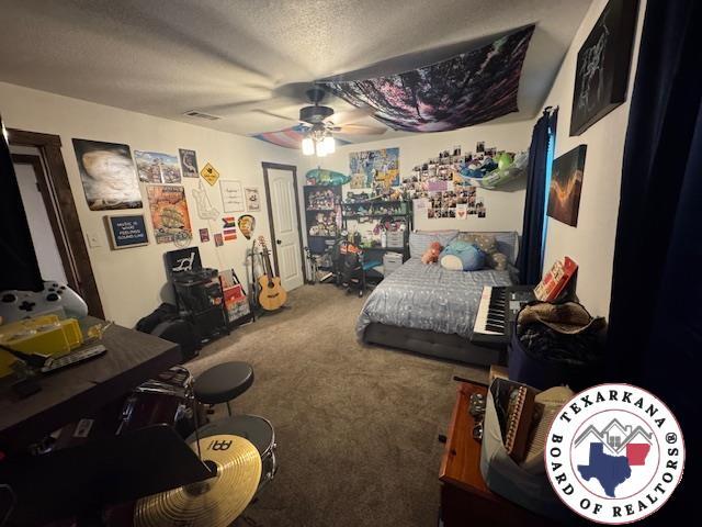 24075 US Highway 59 N, Queen City, TX 75551 - bedroom featuring carpet flooring, a textured ceiling, and ceiling fan