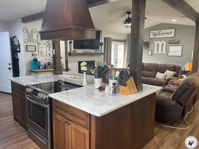 24075 US Highway 59 N, Queen City, TX 75551 - kitchen featuring stainless steel range with electric stovetop, premium range hood, open floor plan, ceiling fan, and dark wood finished floors