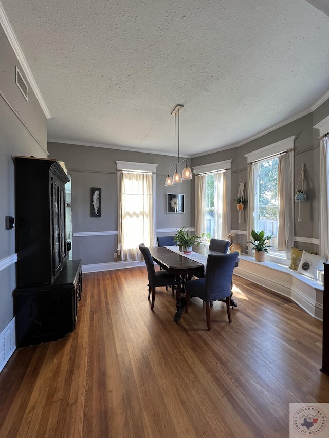 dining space with dark hardwood / wood-style flooring and a textured ceiling