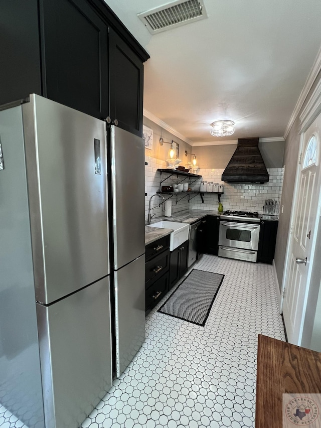 kitchen featuring sink, backsplash, custom range hood, and stainless steel appliances