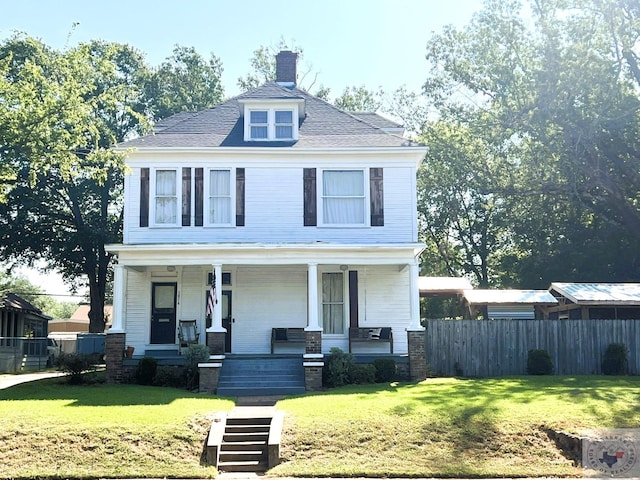 view of front of property with covered porch and a front yard