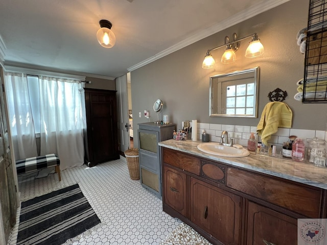 bathroom with crown molding, tasteful backsplash, and vanity