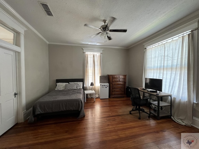 bedroom with crown molding, dark wood-type flooring, a textured ceiling, and ceiling fan