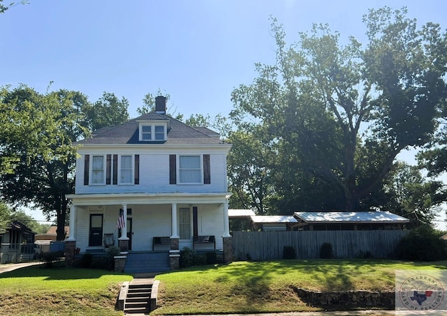 view of front of property with a porch and a front lawn